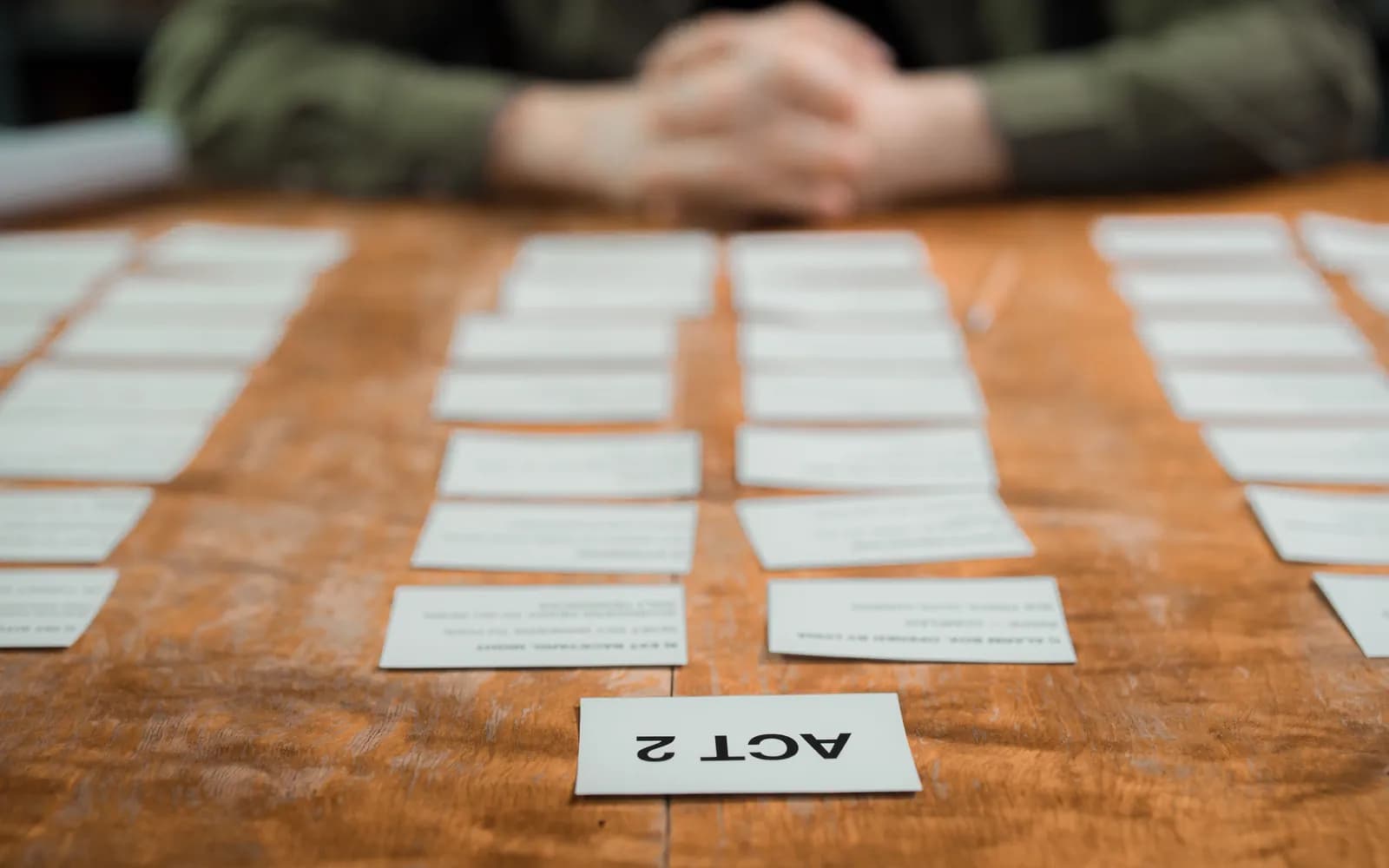Close-up of storyboard cards arranged on a table for scriptwriting planning.