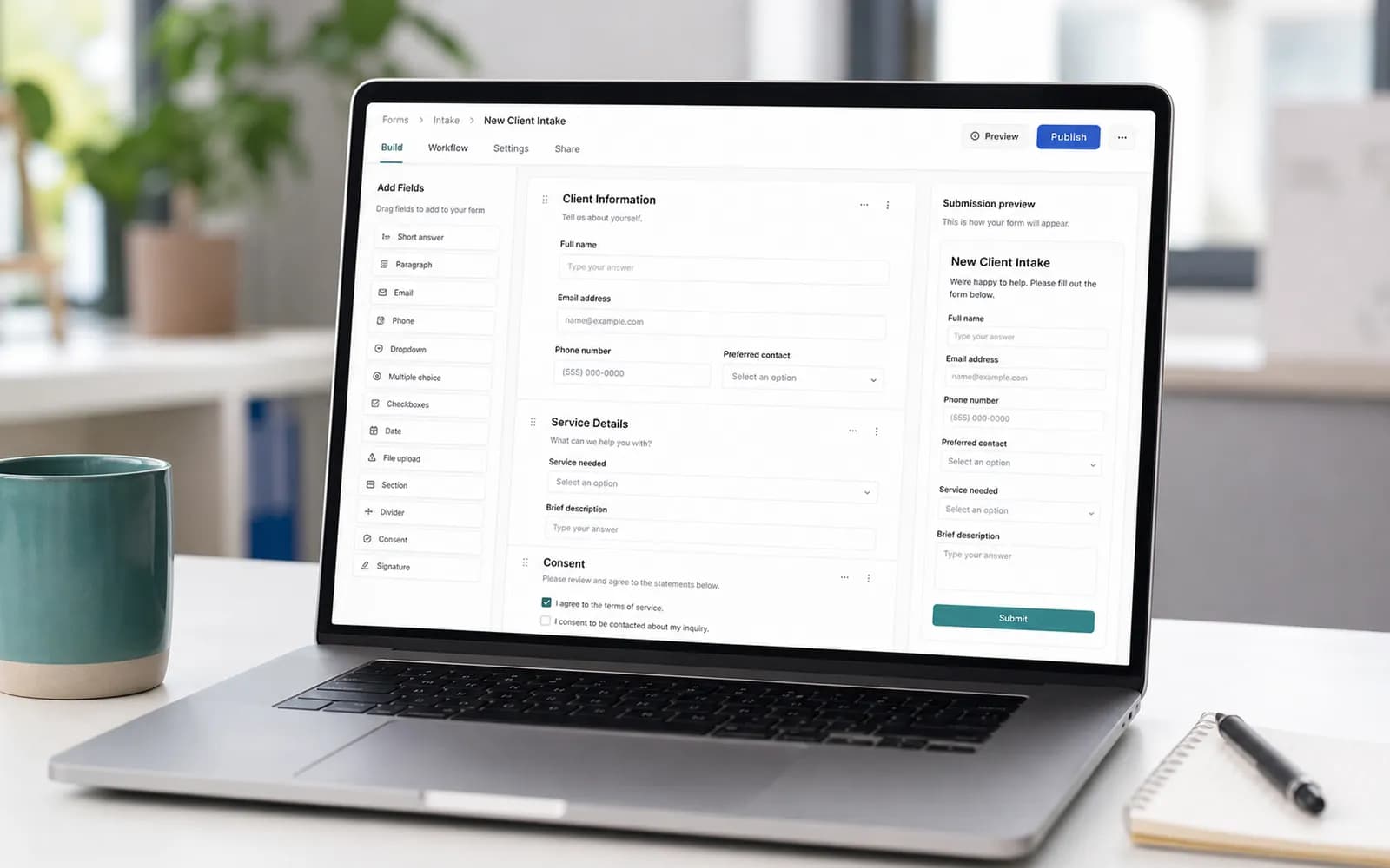 Client intake form builder displayed on a laptop in an office.