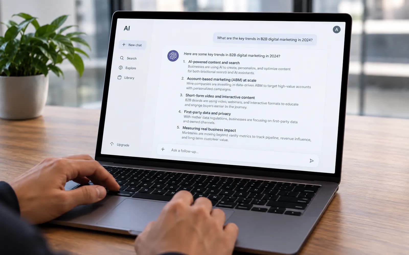 A laptop on a desk showing an AI assistant answering a question about B2B marketing trends.